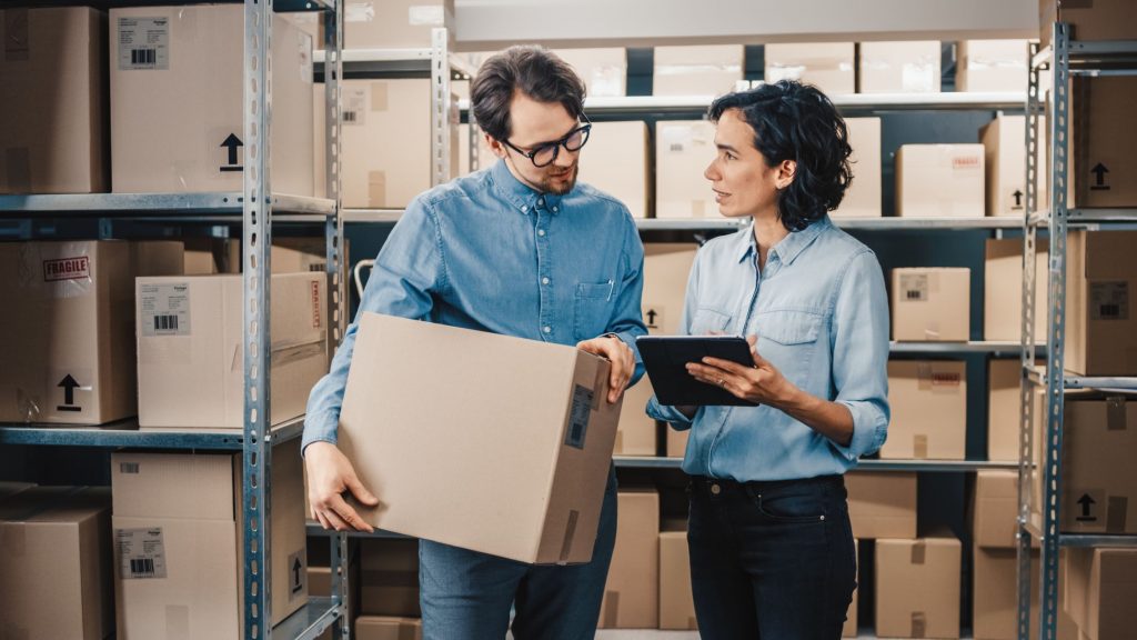 Two employees having a discussion in the stock room