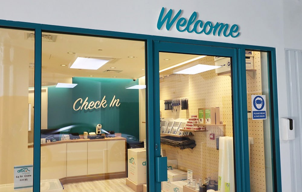 Storage facility entrance with welcome sign and check-in counter.