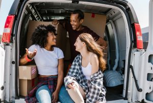 three friends in a moving van